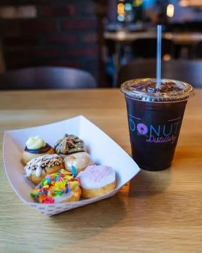 Donut Distillery tray of mini donuts with iced coffee