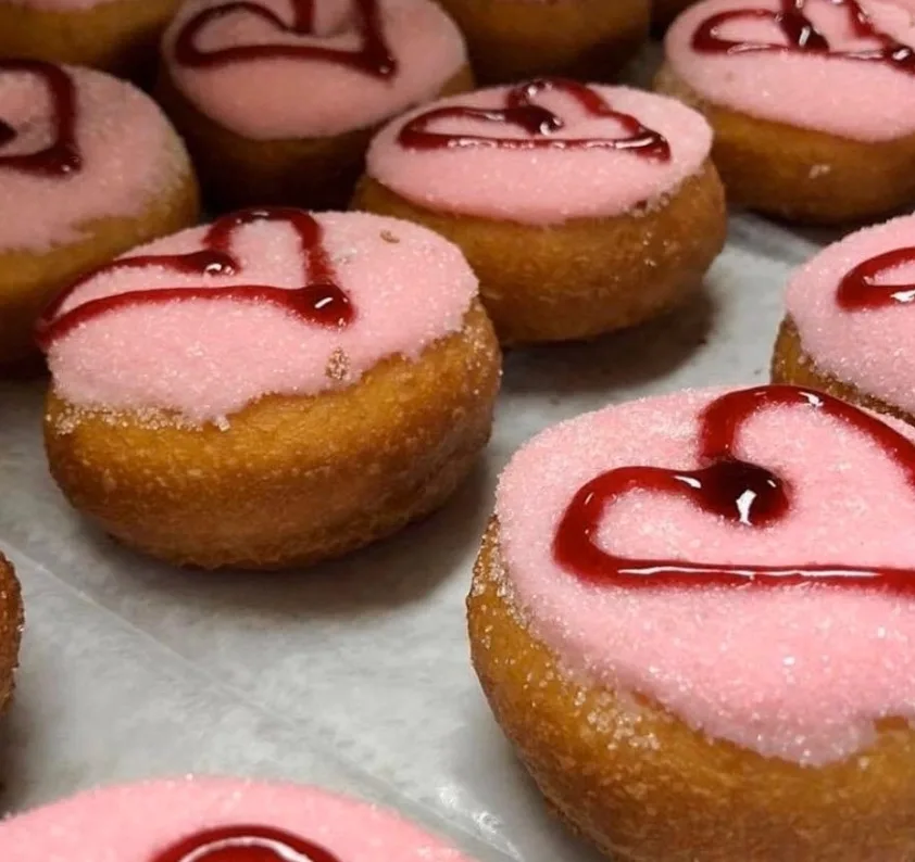Peace, Love & Little Donuts pink heart-decorated mini donuts