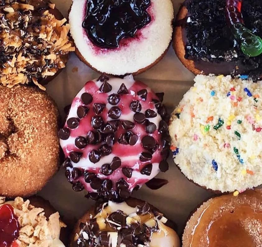 Peace, Love & Little Donuts assorted gourmet decorated mini donuts
